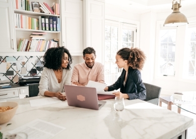 Woman Advisor Meeting with Clients in Their Home